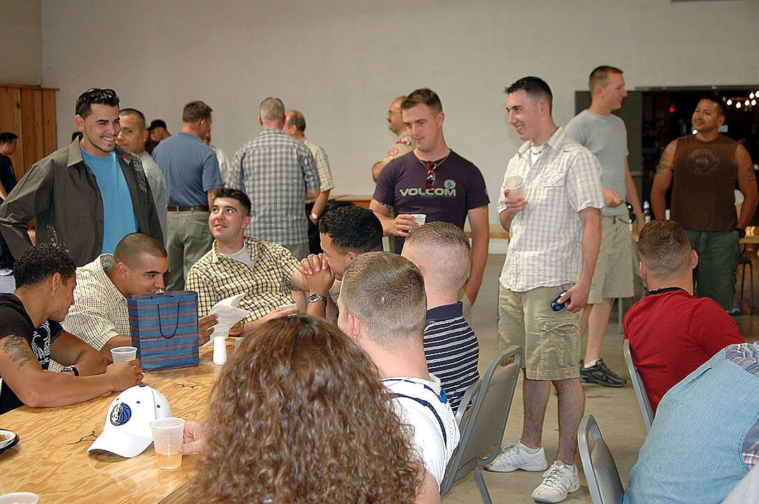 Marines and family members from Marine Attack Squadron-214 take time out to relax and enjoy good camaraderie Friday during a family picnic at Britain's Farm Chuckwagon and Steakhouse. The event was the first time VMA-214 had the opportunity to relax as a full unit after returning from deployments and working as the sole Harrier support squadron for Weapons and Tactics Instructor course 2-05. Besides relaxing and socializing, the Marines participated in sporting events and enjoyed a Texas-style barbeque during the picnic.