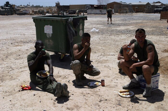 CAMP FALLUJAH, Iraq -- Marines from Maintenance Company, Combat Logistics Battalion 8, 2d Force Service Support Group (Forward), enjoy hamburgers and hotdogs during Maint. Co.'s fun day.  The fun day was to give the Marines a break from the normal 12 to 18 hour workdays they are used to.