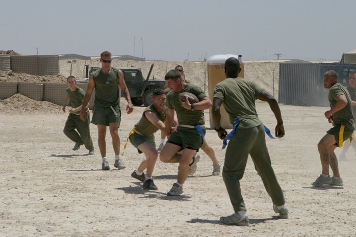 CAMP FALLUJAH, Iraq -- Playing flag foot ball as part of Maintenance Company's fun day is Sgt. Robert Topper, Engineer Maintenance Platoon, platoon sergeant.  The Atlanta native tries to evade a "tackler."  Maintenance Company is part of Combat Logistics Battalion 8, 2d Force Service Support Group (Forward).  ::n::