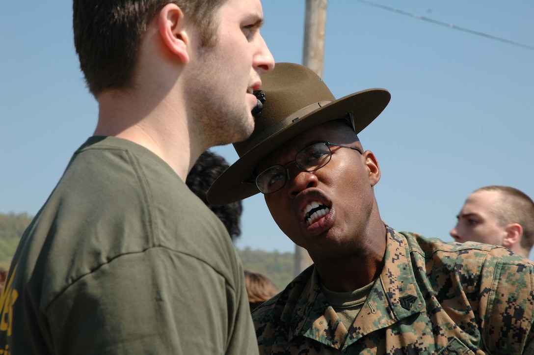 Sergeant Paul Nixon, drill instructor, 3rd Recruit Training Battalion, Marine Corps Recruit Depot, Parris Island, S.C., gives a poolee some added incentive to do what he?s told.  Approximately 400 future Marines gathered May 7, 2005 at Fort Indian Town Gap, Pa., for Recruiting Station Harrisburg?s Annual Future Marine Challenge. The purpose of the event is to familiarize the future Marines with boot camp and to allow them to learn about teamwork and camaraderie.