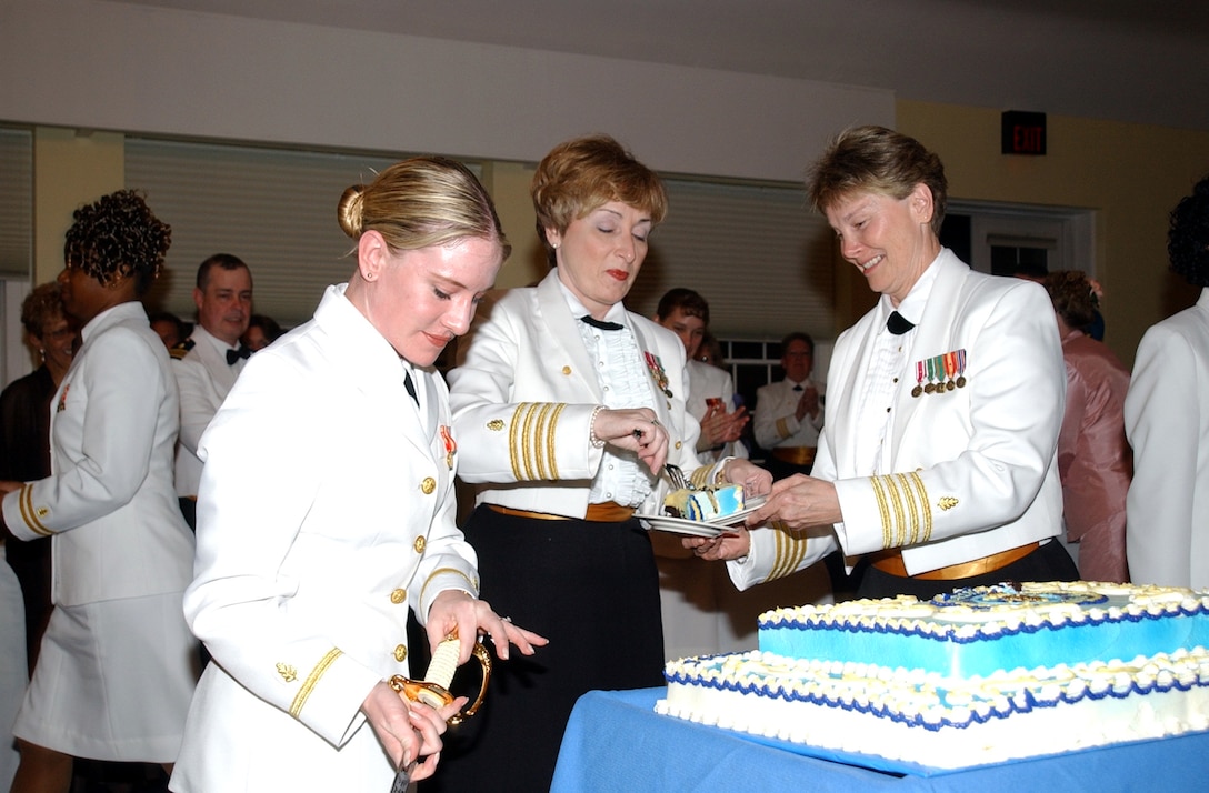 MARINE CORPS BASE CAMP LEJEUNE, N.C. - Ensign Julie Thomas, a navy nurse at the naval hospital, Capt. Patricia Netzer, officer in charge of the health care supply office in Norfolk, Va., and Capt. Nancy Simmons, senior nurse executive at the naval hospital, serve cake at the Navy Nurse Corps Birthday Ball at the Officer's Club May 7. The theme for this year's celebration, Nurses: Many Roles, One Profession, reflects the growing and expanding roles nurses face. At the naval hospital, this is compounded by deployments and training requirements that add to the stresses already come endured with being nurse. (Official Marine Corps photo by Pfc. Drew Barker)