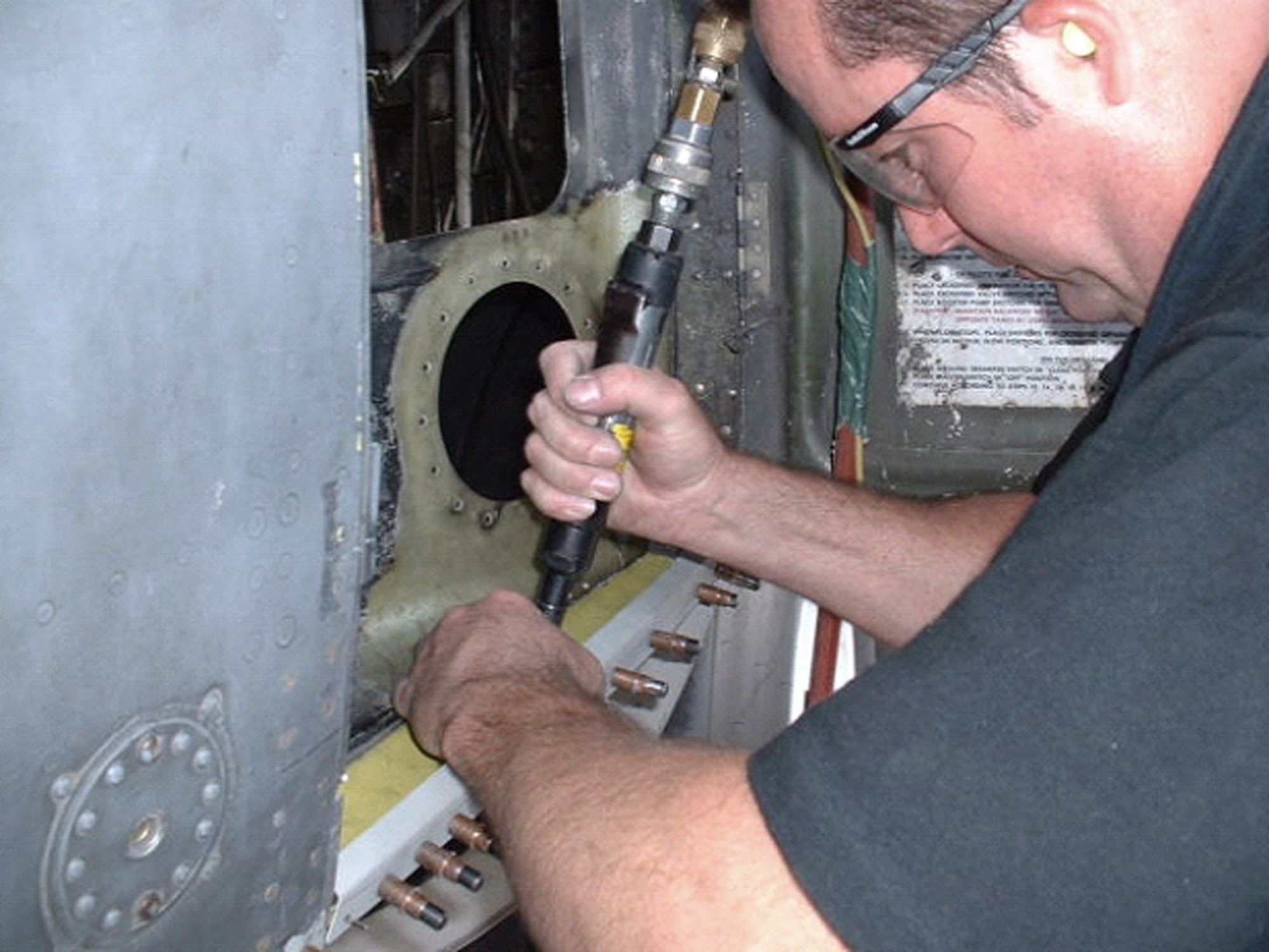 KARSHI-KHANABAD AIR BASE, Uzbekistan -- Tech. Sgt. Jimmy Shaw works on a piece of framework on a damaged C-130 Hercules as part of an in-field depot maintenance effort by maintainers here.  He is a C-130 structural craftsman deployed from the Texas Air National Guard at Fort Worth.  (U.S. Air Force photo by Master Sgt. William Stuhr)