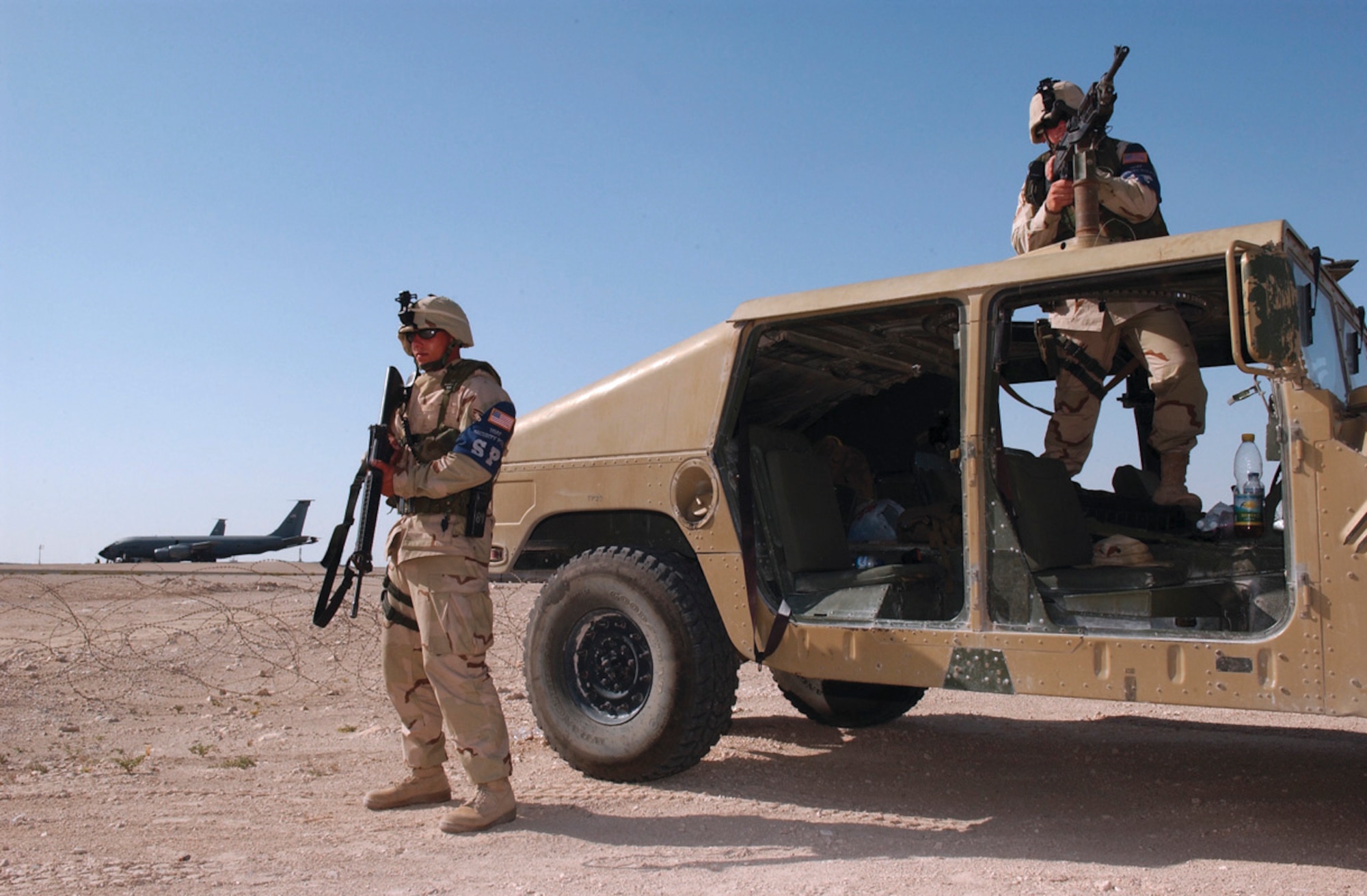 SOUTHWEST ASIA -- Two 379th Expeditionary Security Forces Squadron Airmen guard the flightline perimeter at a forward-deployed location.  (U.S. Air Force photo by Staff Sgt. Colette Bennett)
