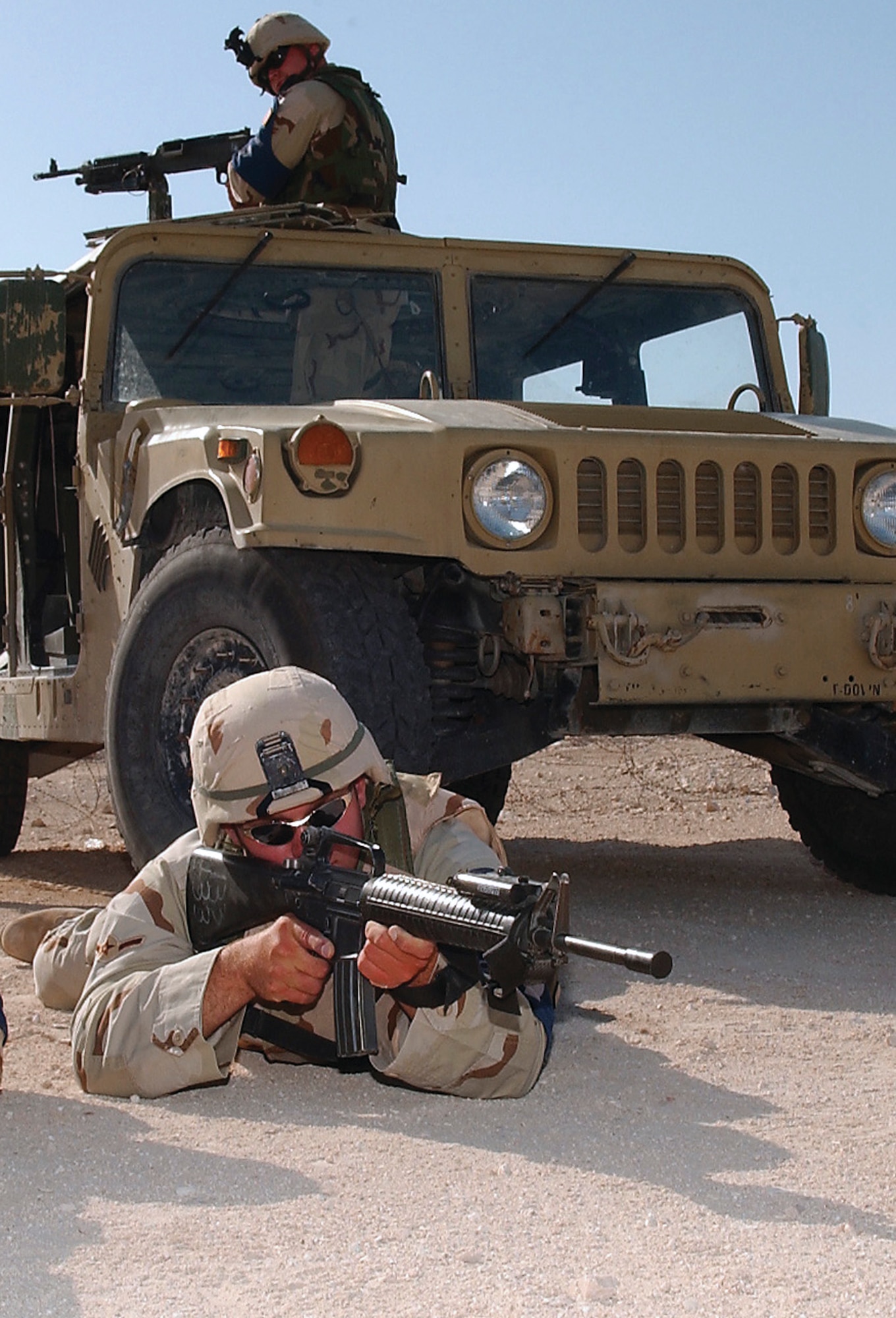 SOUTHWEST ASIA -- Two 379th Expeditionary Security Forces Squadron Airmen guard the flightline perimeter at a forward-deployed location.  (U.S. Air Force photo by Staff Sgt. Colette Bennett)