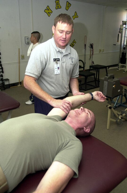 MARINE CORPS BASE CAMP LEJEUNE, N.C. - Petty Officer 2nd Class Leslie Cantrell, lead petty officer of sports medicine, works on Gunnery Sgt. Daniel Goyer, from 2d Marine Division Communication Company, at the Camp Lejeune Sports Medicine and Reconditioning Team Clinic May 9. The clinic, which helps injured Marines and Sailors recover quickly from mild and moderate injuries, has been in operation since 2001 and has helped more than 88,000 patients during that time span. (Official Marine Corps photo by Lance Cpl. Shane Suzuki)