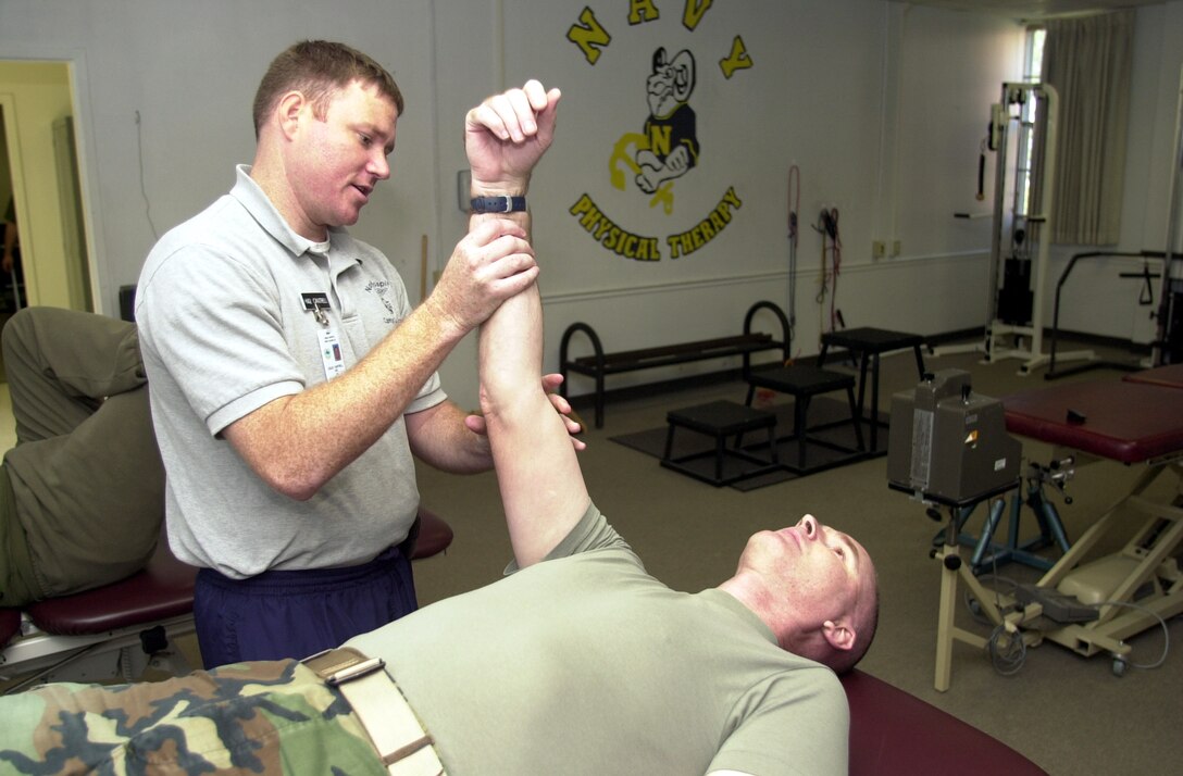 MARINE CORPS BASE CAMP LEJEUNE, N.C. - Petty Officer 2nd Class Leslie Cantrell, lead petty officer of sports medicine, works on Gunnery Sgt. Daniel Goyer, from 2d Marine Division Communication Company, at the Camp Lejeune Sports Medicine and Reconditioning Team Clinic May 9. The clinic, which helps injured Marines and Sailors recover quickly from mild and moderate injuries, has been in operation since 2001 and has helped more than 88,000 patients during that time span. (Official Marine Corps photo by Lance Cpl. Shane Suzuki)