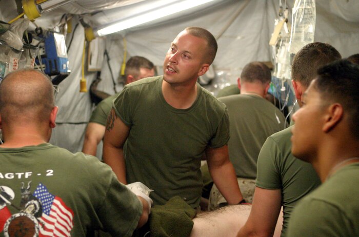 United States Navy Surgeons and Nurses, from the 2D FSSG Surgical Shock Trama Platoon (SSTP), treat wounded United States Marines inside the emergency rooms of the Camp Al Taqaddum SSTP, on May 10, 2005.  Three Marines would be treated for wounds caused by an IED explosion.  (U.S.M.C. photo taken by LCpl Brian A. Jaques)