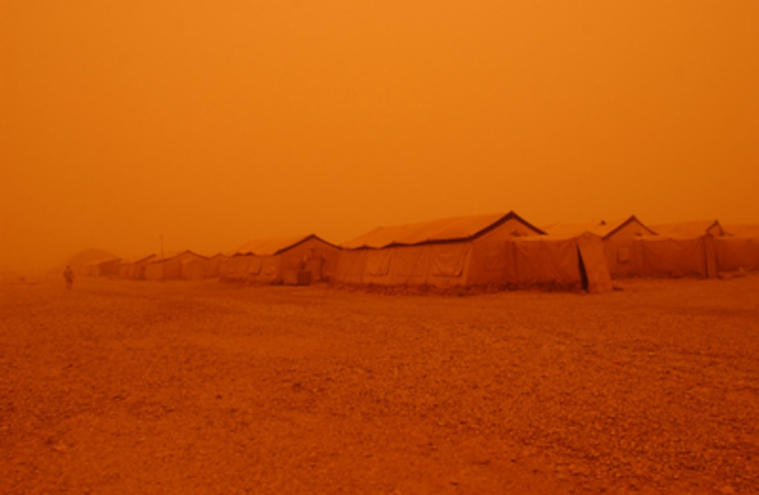 A sand storm hovers over Tallil Air Base, Iraq, turning the sky and everything else a hazy yellow-orange color on May 5, 2005. 