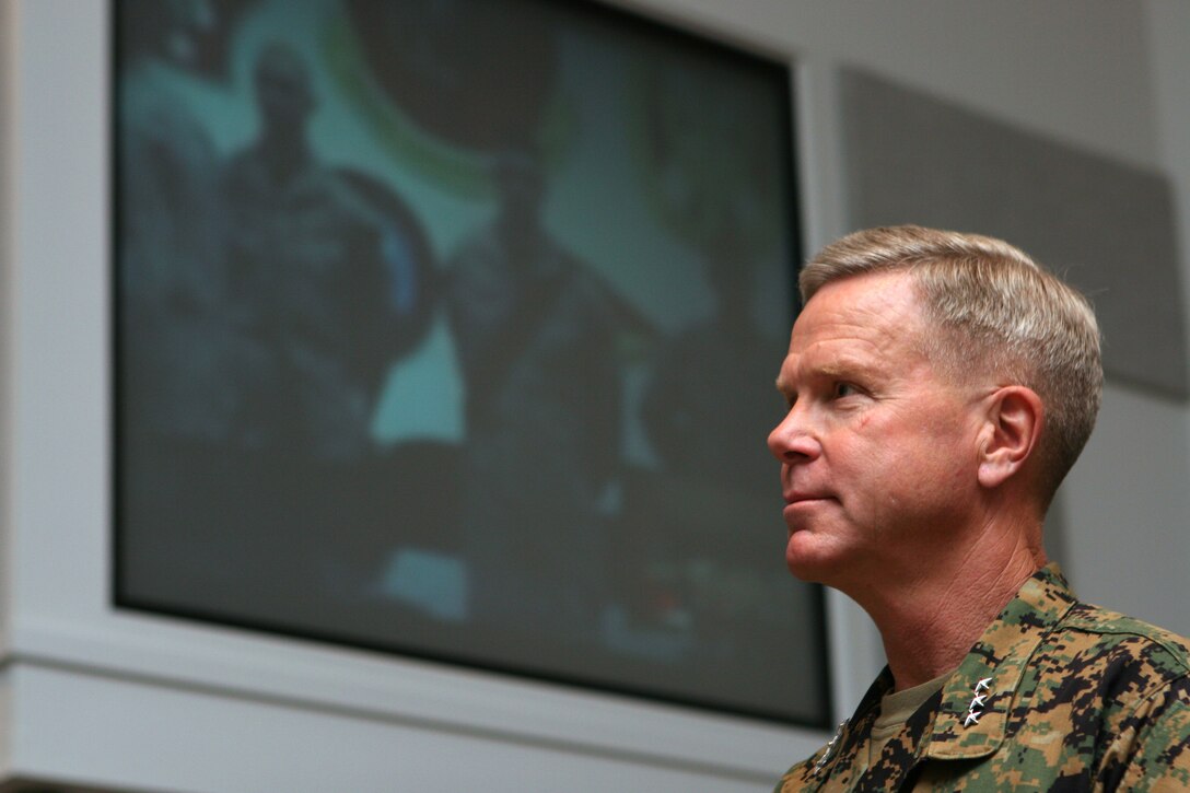 Lt. Gen. James F. Amos, commanding general, II MEF, listens to remarks by Capt. Matt Youngblood, commanding officer of B Co., 2nd Tank Bn., from Iraq via video teleconference.  B Co. was named winner of the Lt. Gen. Chesty Puller Award for oustanding unit leadership in the small unit category.