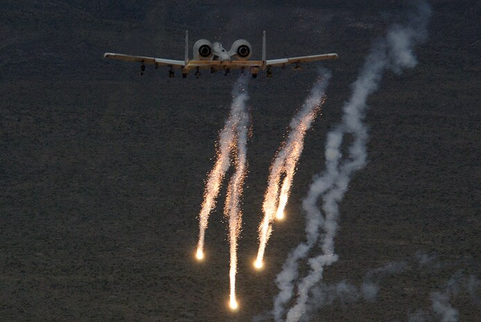 NELLIS AIR FORCE BASE, Nev. -- An A-10 Thunderbolt II releases chaff and flares during a close-air support mission May 5.  A-10s are specially designed for close-air support of ground forces.  They are simple, effective and survivable twin-engine jet aircraft that can be used against ground targets, including tanks and other armored vehicles.  This aircraft is assigned to the 66th Weapons Squadron here.  (U.S. Air Force photo by Tech. Sgt. Kevin J. Gruenwald)