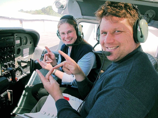 SEATTLE -- Rob Drake and his pilot instructor, Senior Airman Christy Helgeson, sign the word for "perfect" in the plane he had a solo flight in.  Airman Helgeson taught Mr. Drake, who is deaf, how to fly.  She is a reservist with the 446th Aircraft Maintenance Squadron at nearby McChord Air Force Base.  (U.S. Air Force photo by Staff Sgt. Wendy Beauchaine)