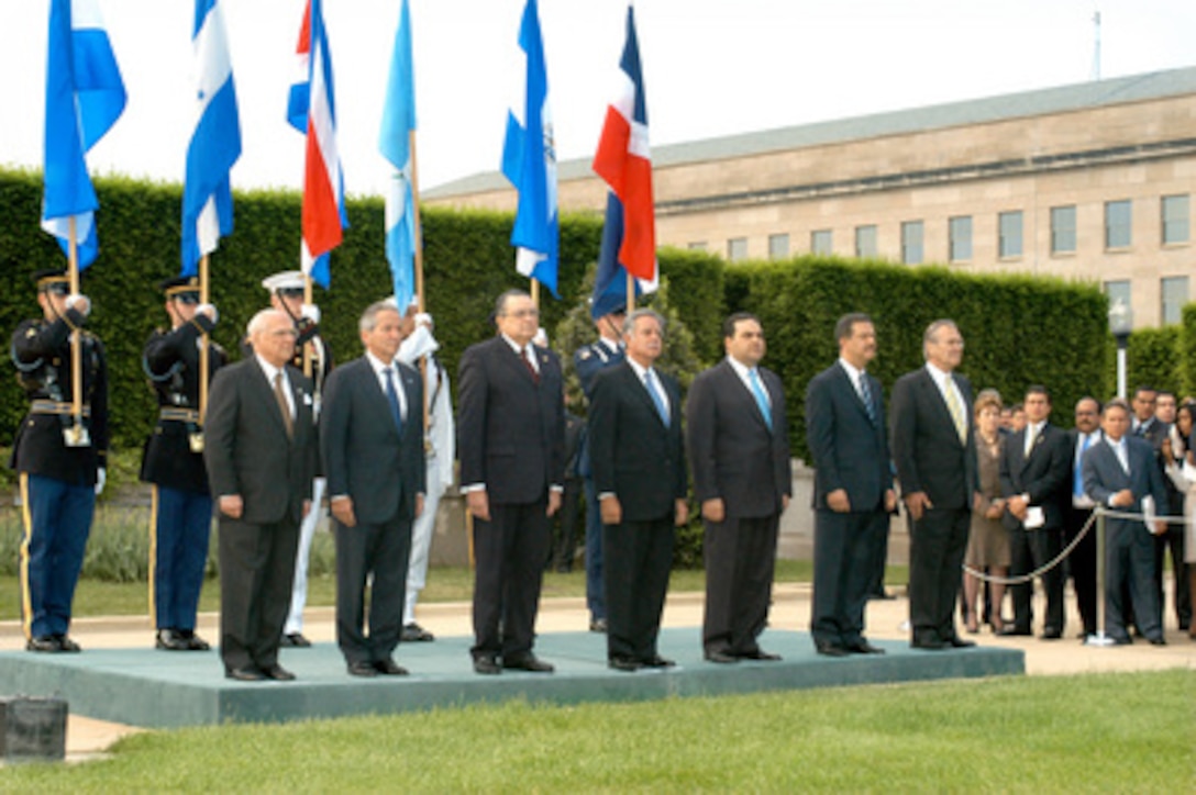 Six presidents of Central American and Caribbean nations stand on the reviewing platform with their host Secretary of Defense Donald H. Rumsfeld (right) during an armed forces full honor review at the Pentagon's River Parade Field on May 11, 2005. The presidents are (left to right): Enrique Bolanos of Nicaragua, Ricardo Maduro of Honduras, Abel Pacheco of Costa Rica, Oscar Berger of Guatemala, Antonio Saca of El Salvador, and Leonel Fernandez of the Dominican Republic. The Central American and Caribbean leaders are at the Pentagon for security discussions. The full honor review featured a 21-gun salute followed by a pass-in-review of the honor guard platoons of each of the five U.S. armed services. 