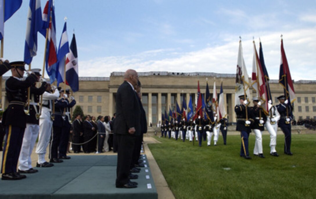 Six presidents of Central American and Caribbean nations stand on the reviewing platform with their host Secretary of Defense Donald H. Rumsfeld during an armed forces full honor review at the Pentagon's River Parade Field on May 11, 2005. The Central American and Caribbean leaders are at the Pentagon to for security discussions. The full honor review featured a 21-gun salute followed by a pass-in-review of the honor guard platoons of each of the five U.S. armed services. Rumsfeld and Presidents Enrique Bolanos of Nicaragua, Ricardo Maduro of Honduras, Abel Pacheco of Costa Rica, Oscar Berger of Guatemala, Antonio Saca of El Salvador, and Leonel Fernandez of the Dominican Republic will later discuss security concerns during a breakfast meeting in the Pentagon. 