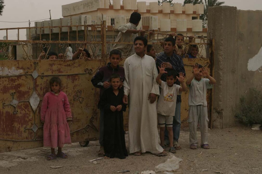 AL UBAYDI, Iraq-  (May 12, 2005)  Children wave and accept candy from Marines.  Marines from 3/2 secure Al Ubaydi during operation Matador.  Marines from 3rd Battalion, 2nd Marine Regiment conducting Security and Stabilization Operations (SASO) in support of Operation Iraqi Freedom III (OIF III).