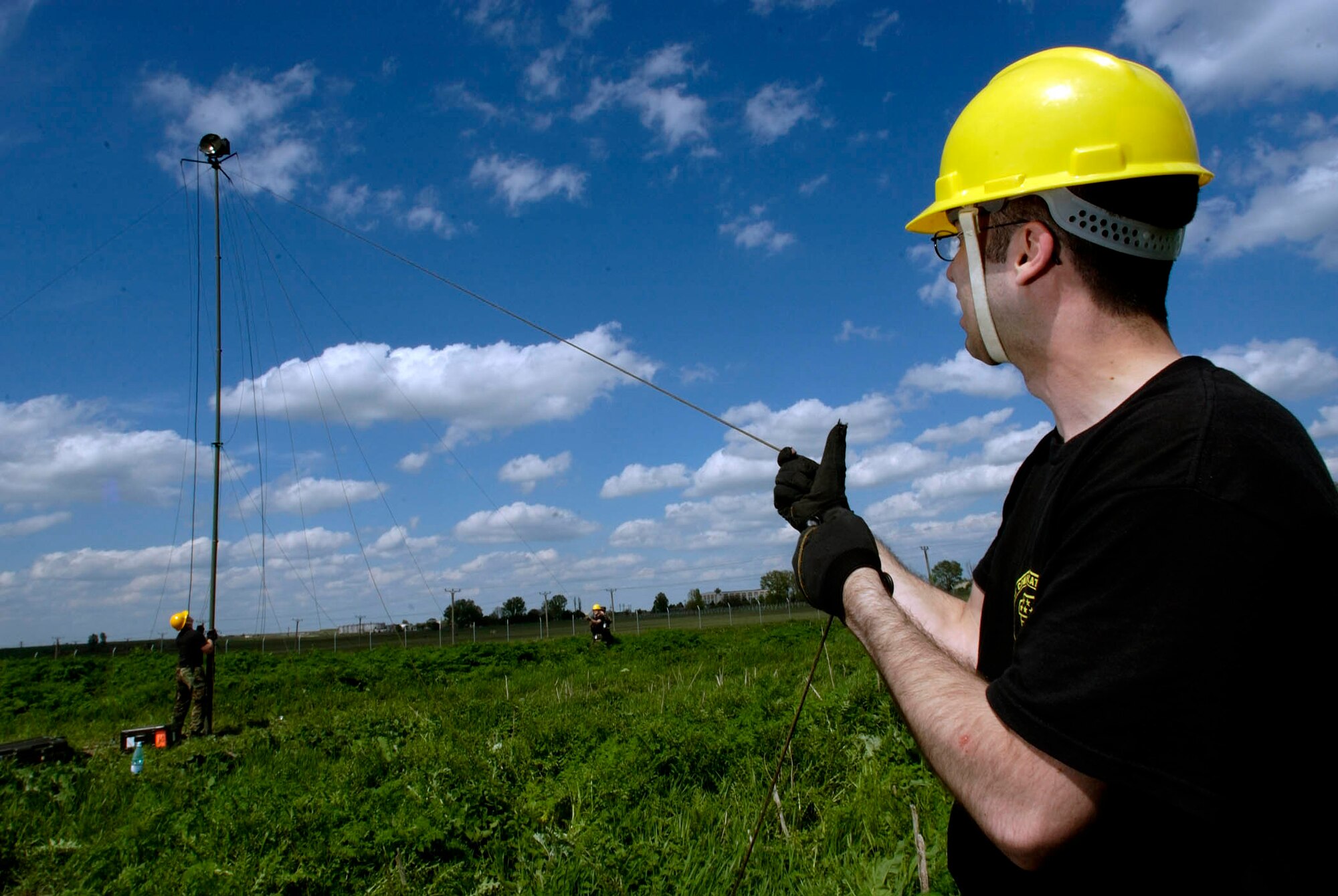 MIHAIL KOGALNICEANU AIRFIELD, Romania -- Senior Airmen Jason Dunigan holds the line as a mast with a modulator is raised here for exercise Combined Endeavor 2005.  Airman Dunigan is assigned to the 1st Combat Communications Squadron from Ramstein Air Base, Germany, that is preparing communications equipment to conduct more than 1,400 interoperability tests.  (U.S. Air Force photograph by Master Sgt. John Lasky)