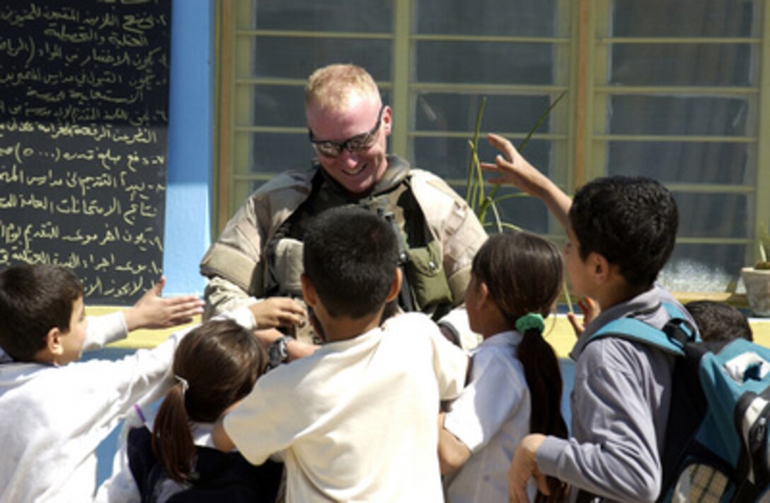 Iraqi children receive toys and school supplies from U.S. Army soldiers of the10th Mountain Division at the College of Agriculture in Abu Ghraib, Iraq, on May 8, 2005. The Veterans of Foreign Wars donated the toys and supplies for the Iraqi children. The soldiers are assigned to the 10th Mountain Division Civil affairs Team. 