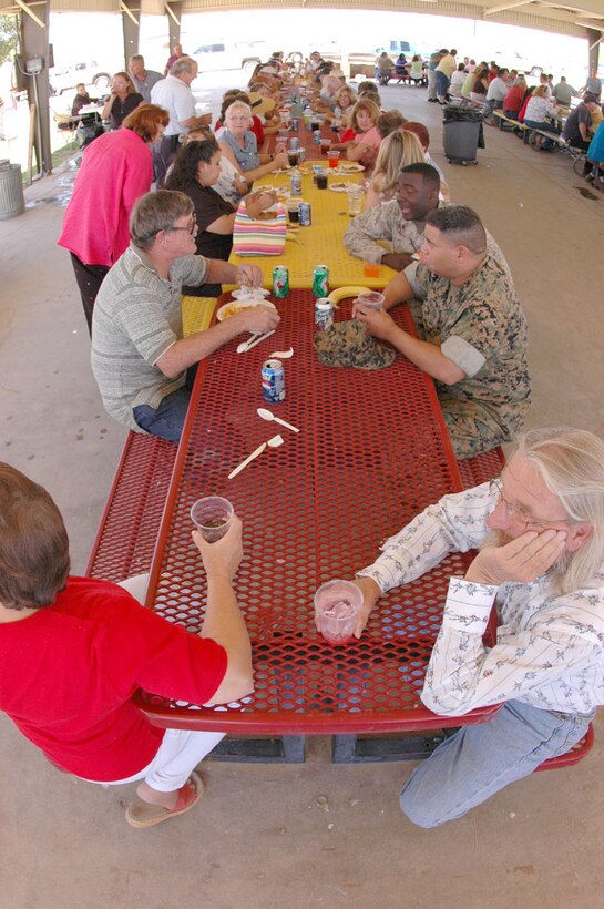 A group of station personnel eat lunch during the station's annual civilian employee picnic at Ramada Field May 13. Attendees enjoyed a catered lunch from the Sonoran Pueblo consolidated club. Additionally 35 random civilian employees also received gift certificates ranging in value from $25 to $150, to businesses out in town including Best Buy, Applebee's and Sears