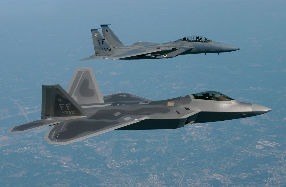 OVER VIRGINIA -- Lt. Col. James Hecker (foreground) delivers the first operational F/A-22 Raptor to its permanent home at Langley Air Force Base, Va., on May 12.  This is the first of 26 Raptors to be delivered to the 27th Fighter Squadron.  The Raptor program is managed by the F/A-22 System Program Office at Wright-Patterson AFB, Ohio.  Colonel Hecker is the squadron's commander.  (U.S. Air Force photo by Tech. Sgt. Ben Bloker)