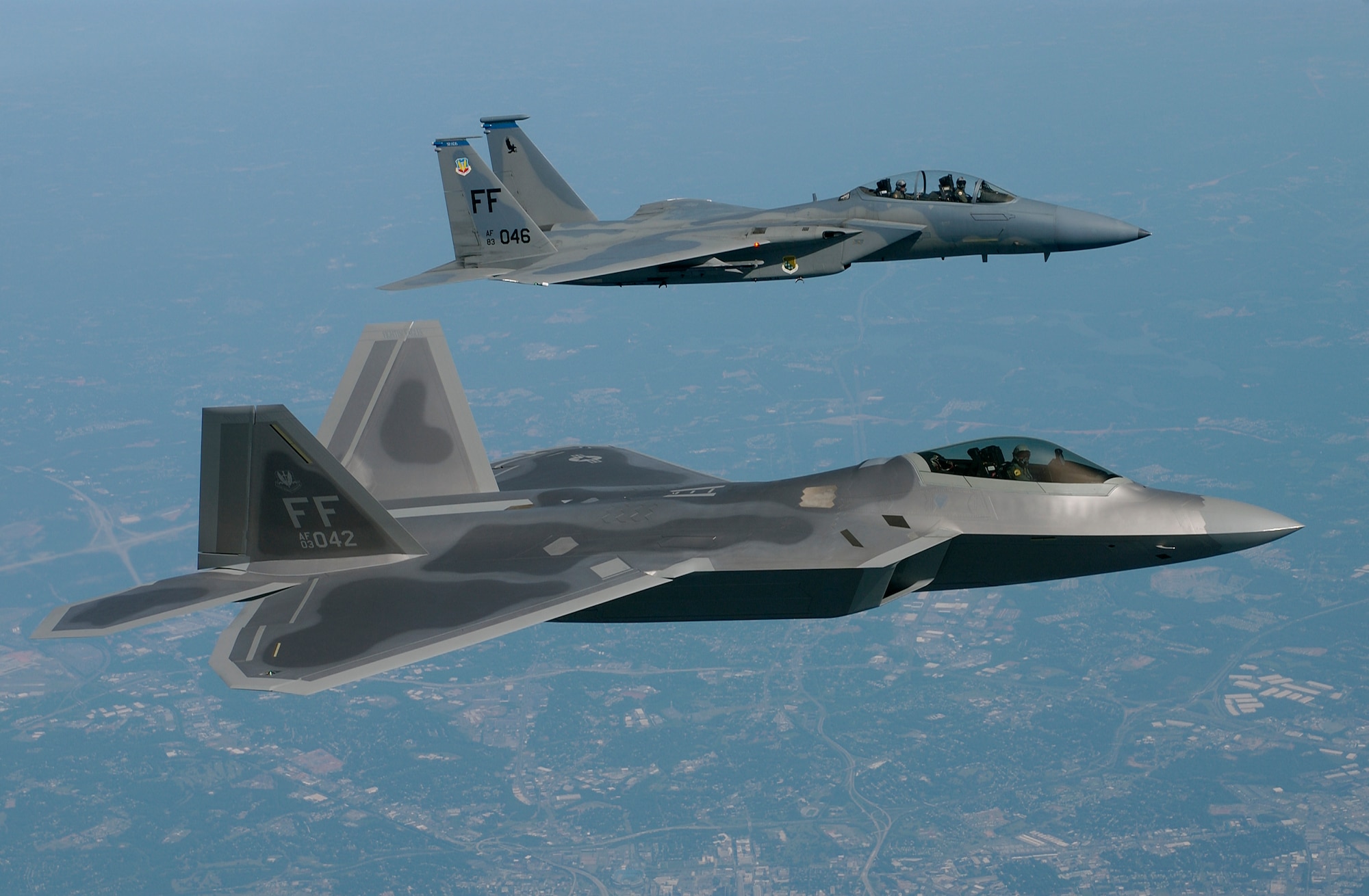 OVER VIRGINIA -- Lt. Col. James Hecker (foreground) delivers the first operational F/A-22 Raptor to its permanent home at Langley Air Force Base, Va., on May 12.  This is the first of 26 Raptors to be delivered to the 27th Fighter Squadron.  The Raptor program is managed by the F/A-22 System Program Office at Wright-Patterson AFB, Ohio.  Colonel Hecker is the squadron's commander.  (U.S. Air Force photo by Tech. Sgt. Ben Bloker)