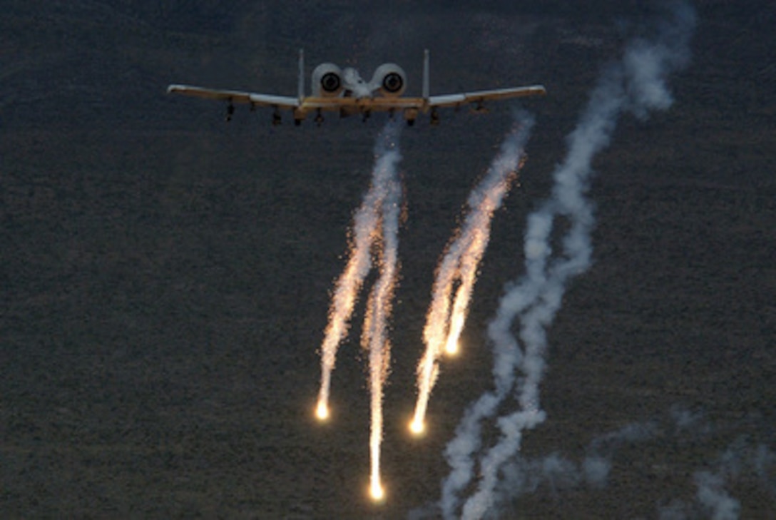 An Air Force A-10 Thunderbolt releases chaff and flares during a close air support mission over the Nevada Test and Training Ranges at Indian Springs, Nev., on May 4, 2005. The Thunderbolt, more commonly called a Warthog, is the first Air Force aircraft specially designed for close air support of ground forces and can be used against all ground targets, including tanks and other armored vehicles. This aircraft is assigned to the 57th Wing, 66th Weapons Squadron. 