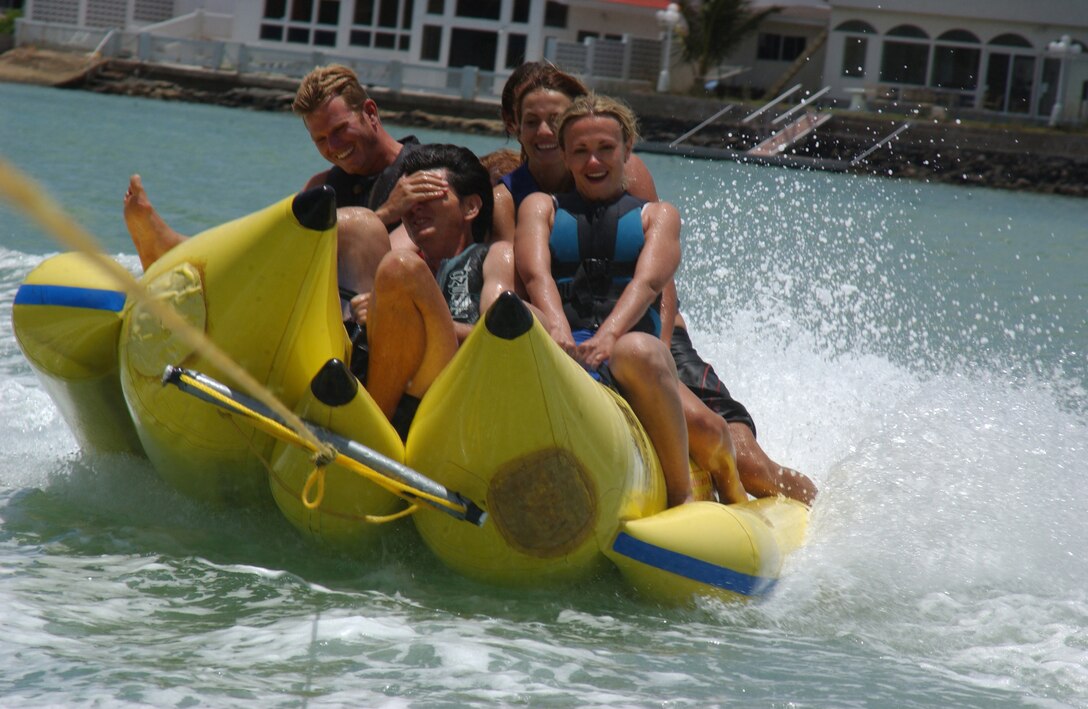 Banana Boat riders fall all over each other as they are flung around a turn in Koko Marina.  The Banana Boat only goes 15 mph, but with the driver making sharp turns, visitors to Hawaii Water Sports can be tossed around easily.  The center offers water skiing, wakeboarding, surfing, scuba and many other activities for water enthusiasts.