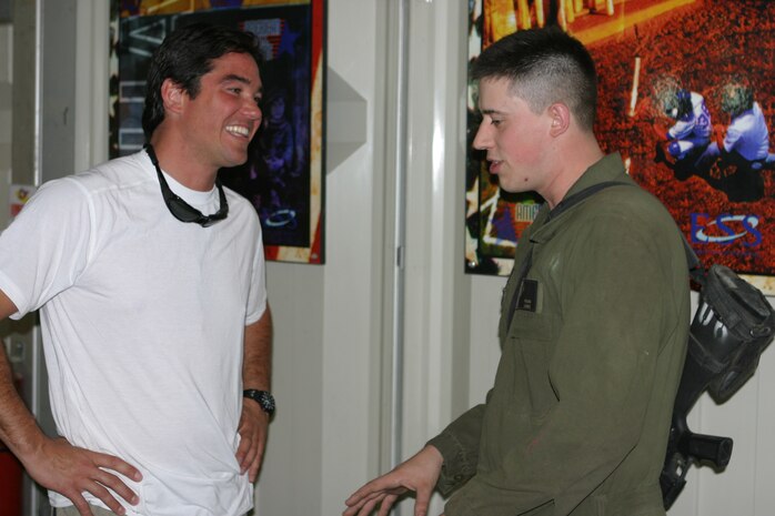 CAMP TAQADDUM, Iraq (May 14, 2005) ? During the Ambassador of Hollywood tour, actor Dean Cain, a Malibu, Calif., native, ran into an old friend of his here May 14. Lance Cpl. Matthew-Michael Tarro of Johnstown, Pa., worked on the set of a movie Cain did a few years back. Cain and Amanda Swisten toured Iraq thanking service members for their sacrifices. (Photo by Sgt. Kristin S. Jochums)
