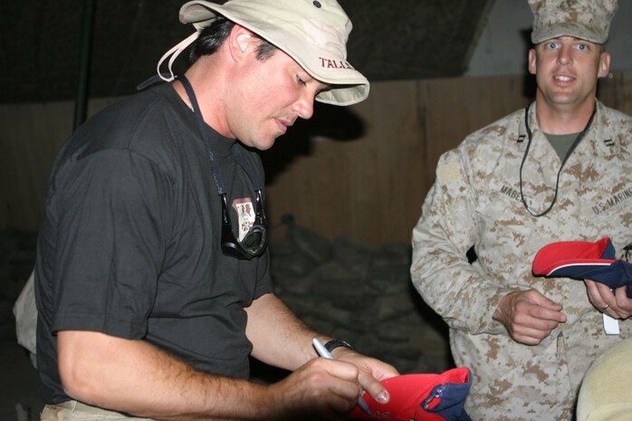 - CAMP TAQADDUM, Iraq (May 14, 2005) ? Dean Cain, a Malibu, Calif., native, takes time to autograph a hat for Capt. Scott J. Mabee, the material readiness officer with Headquarters and Service Battalion, 2d Force Service Support Group (Forward) and Warner