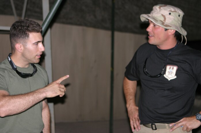 CAMP TAQADDUM, Iraq (May 14, 2005) - Corporal Steven Mattossian, a 21-year-old Los Angeles native, is an aviation supply specialist with Helicopter Marine Medium Squadron 764 who is augmenting Marine Aviation Logistics Squadron 26, socializes with actor and family friend, Dean Cain, a Malibu, Calif., native, here May 14.  Cain and actress Amanda Swisten stopped here to visit with service members as part of the Ambassadors of Hollywood tour.  The two showed their appreciation for the troops by signing autographs and spending time with them. (Photo by Sgt. Kristin S. Jochums)
