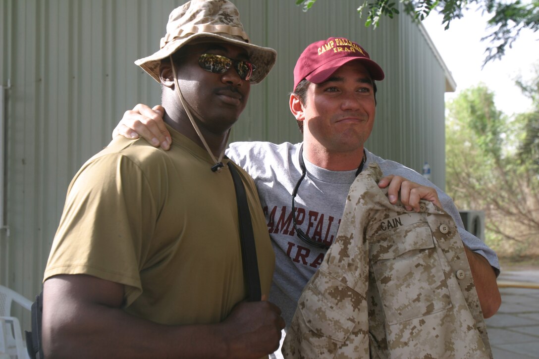 Lance Cpl. Marcus S. Cain, food service, II Marine Expeditionary Force, Headquarters Group, II MEF (FWD), gave his blouse to Dean Cain, actor and producer.  Cain and Amanda Swisten, a model and actress who played in "American Wedding", were in town May 14 and 15 to show an advanced screening of Cain?s newest movie ?Lost?, sign autographs and take photos.
