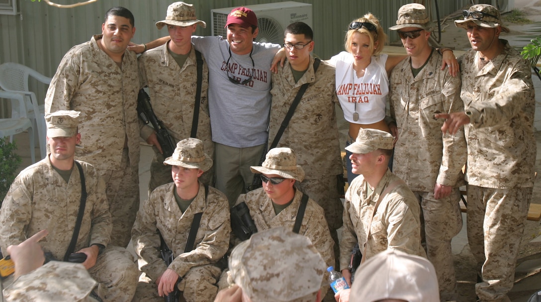 On the morning of May 15, Dean Cain and Amanda Swisten, both actors, pose for a group shot with several Marines, Soldiers, and Sailors during an autograph and photo session in front of the camp exchange. Cain and Swisten, who are touring Iraq for the next few weeks, were on their fourth stop in the country.