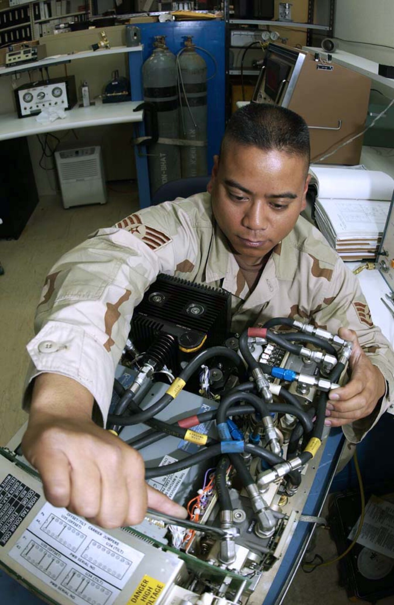 SOUTHWEST ASIA -- Staff Sgt. Freddie Marinas checks for leaks and adjusts the altitude setting on a pressure/temperature test set.  He is assigned to the 379th Expeditionary Maintenance Squadron's precision, measurement and equipment laboratory, and he is deployed from Langley Air Force Base, Va.  (U.S. Air Force photo by Tech. Sgt. Randy Mallard)

