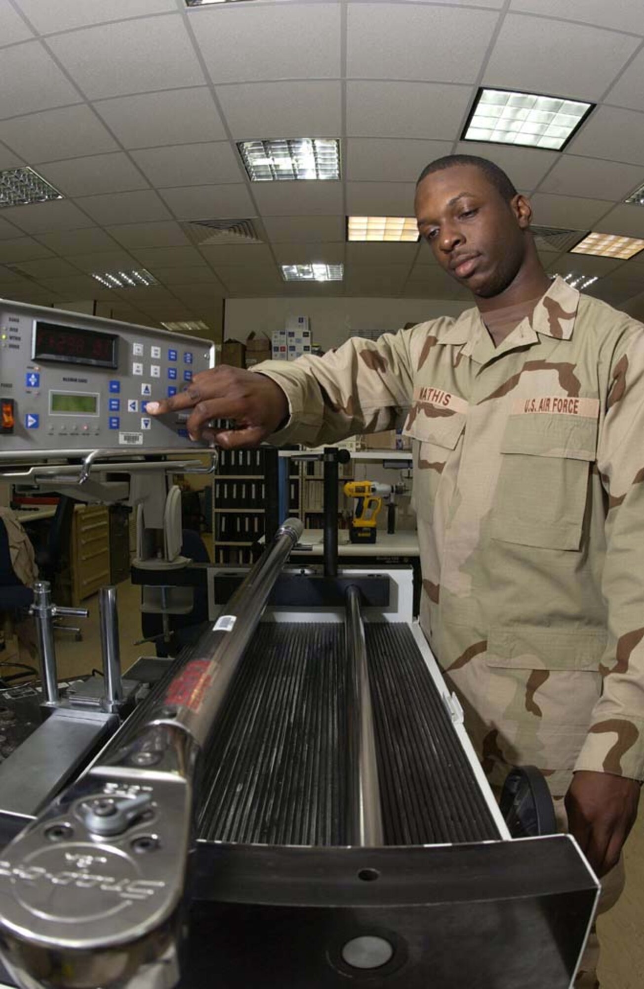 SOUTHWEST ASIA -- Senior Airman Javario Mathis calibrates a torque wrench to ensure it is breaking at the proper torque value.  He is assigned to the 379th Expeditionary Maintenance Squadron's precision, measurement and equipment laboratory, and he is deployed from Charleston Air Force Base, S.C.  (U.S. Air Force photo by Tech. Sgt. Randy Mallard)