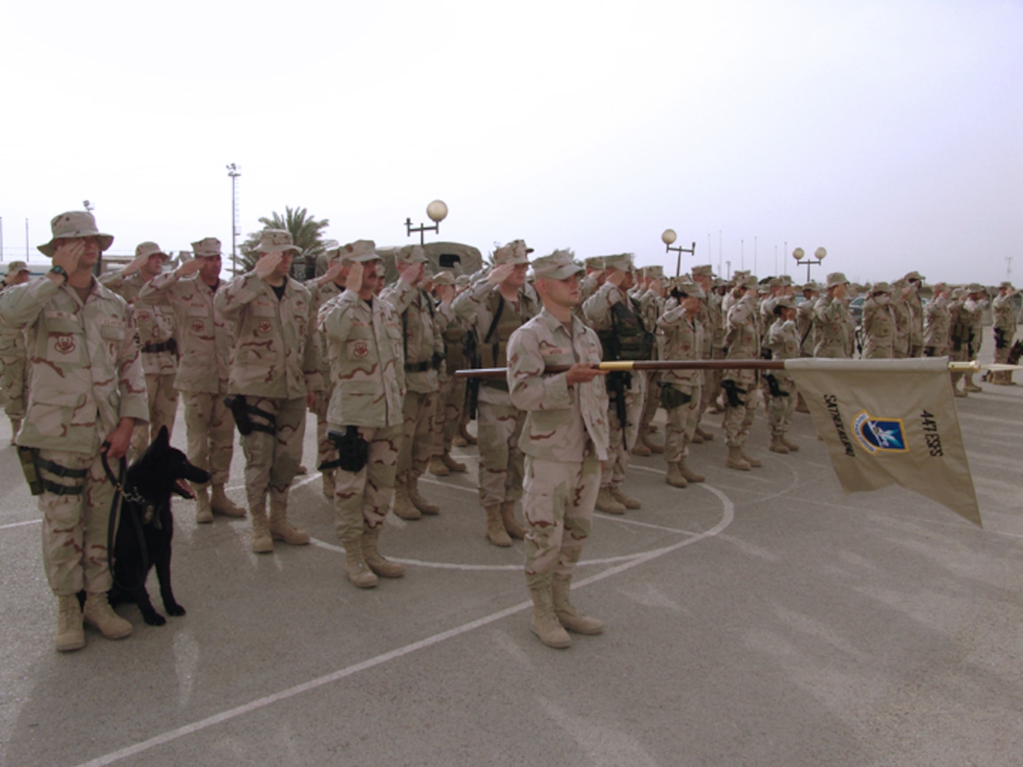 BAGHDAD, Iraq -- Airmen with the 447th Air Expeditionary Group's security forces flight pay tribute to fallen comrades during a ceremony here May 13 observing Peace Officers Memorial Day.  (U.S. Air Force photo by Tech. Sgt. Brian Davidson)  