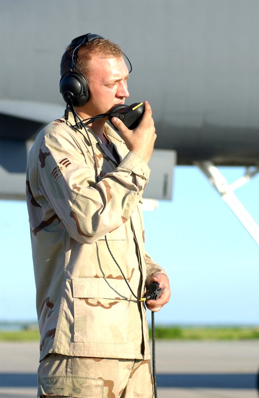 OPERATION ENDURING FREEDOM -- Senior Airman Jon Baker communicates with a pilot during the initial startup of a B-1B Lancer. He is a crew chief with the 40th Expeditionary Maintenance Squadron at a forward-deployed location.  (U.S. Air Force photo by Airman 1st Class Anthony Ennamorato)