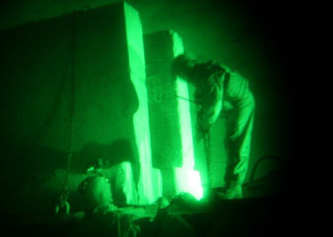 Marines from Transportation Support Company secure 10,000-pound concrete barriers before delivering them to an Iraqi Police Station in Saqlawiyah, Iraq March 20.