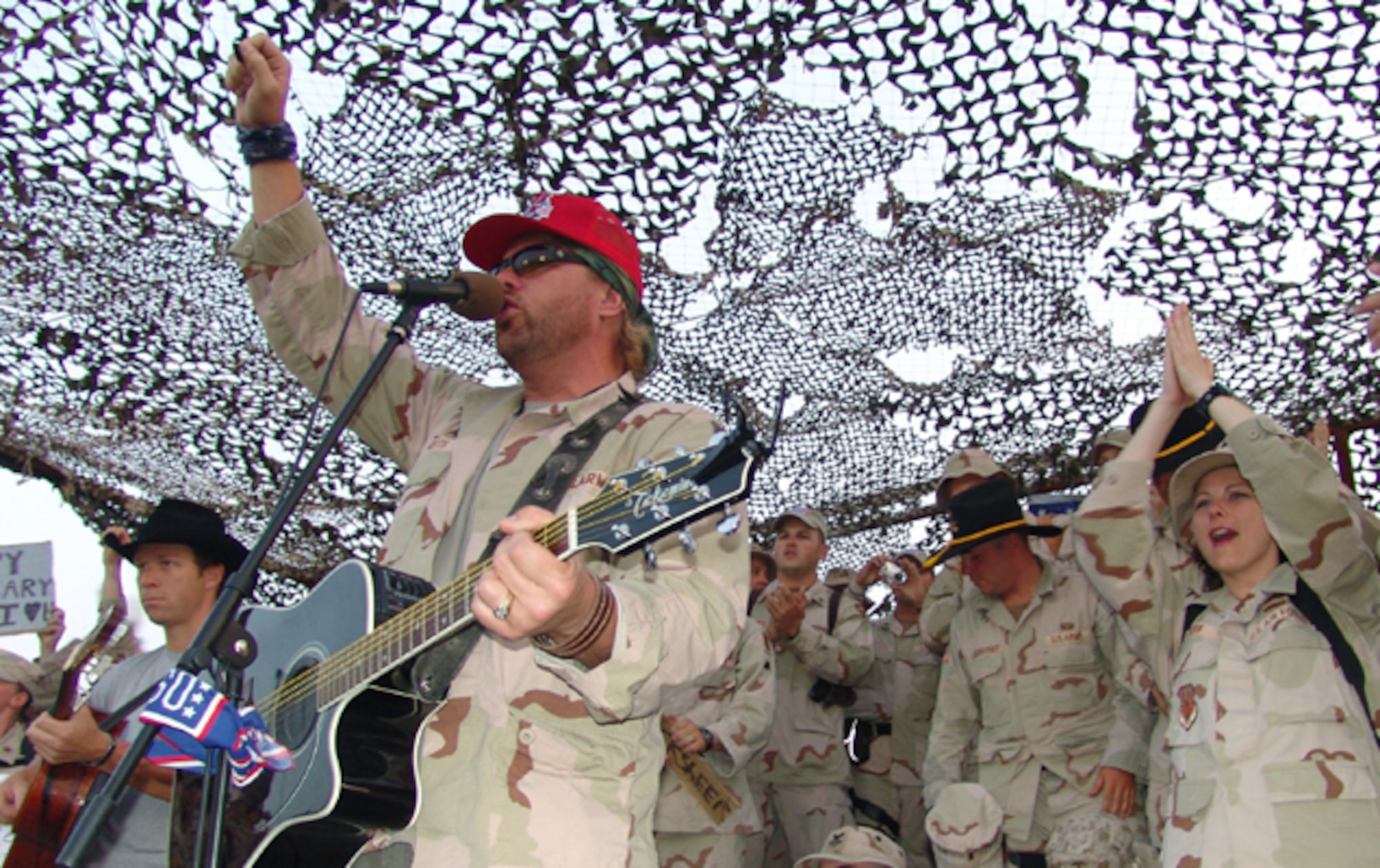 BAGHDAD, Iraq - Country music star Toby Keith performs in a makeshift outdoor auditorium as troops enjoy a break from deployed life May 17.  (U.S. Air Force photo by Tech. Sgt. Brian Davidson)    