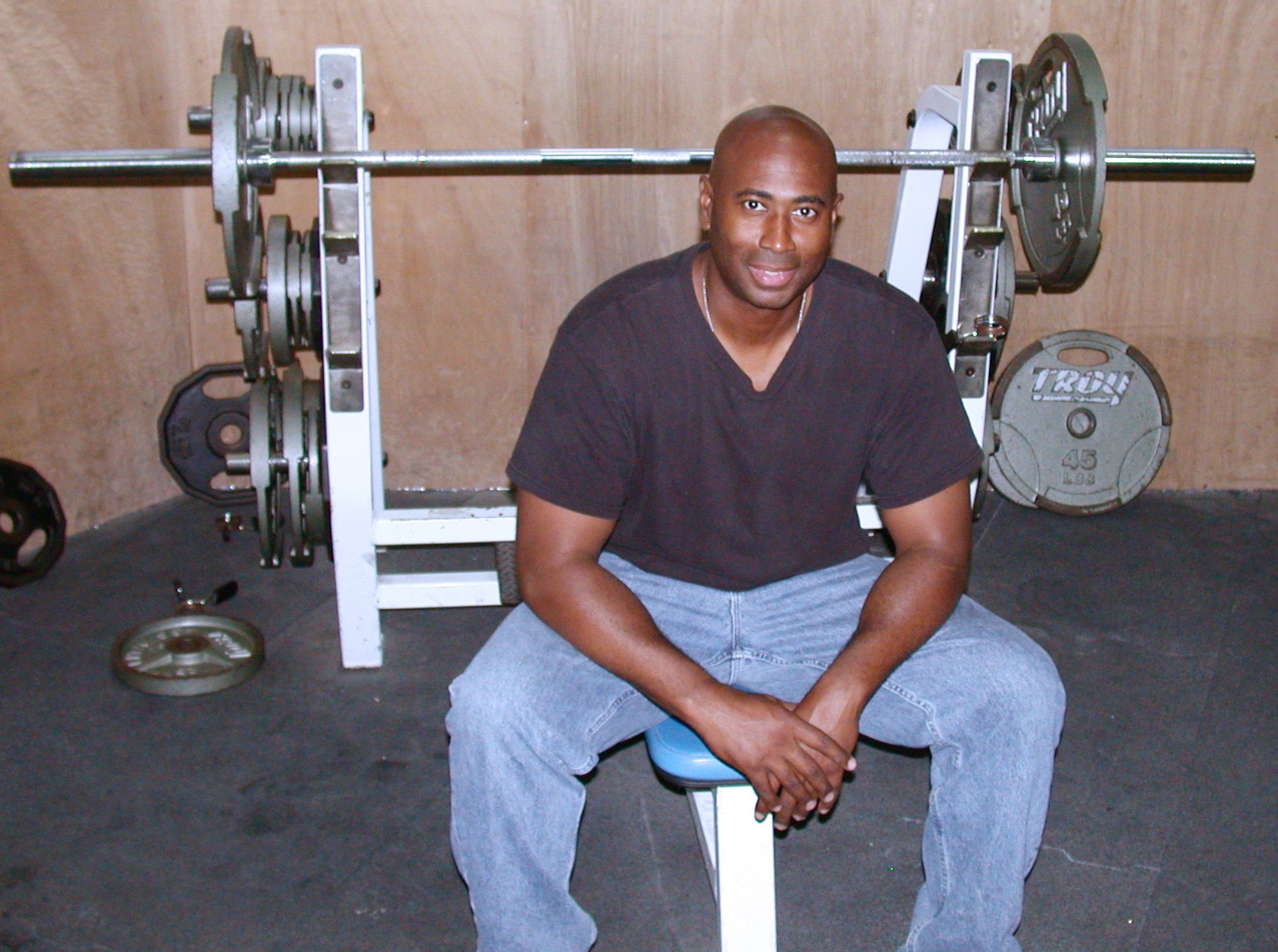 SOUTHWEST ASIA -- Staff Sgt. Reginald Johnson lost 33 pounds while helping fellow deployed Airmen shed unwanted pounds.  He is the fitness center manager with the 380th Expeditionary Services Squadron at a forward-deployed location.  (U.S. Air Force photo by Master Sgt. Michael Ward)

