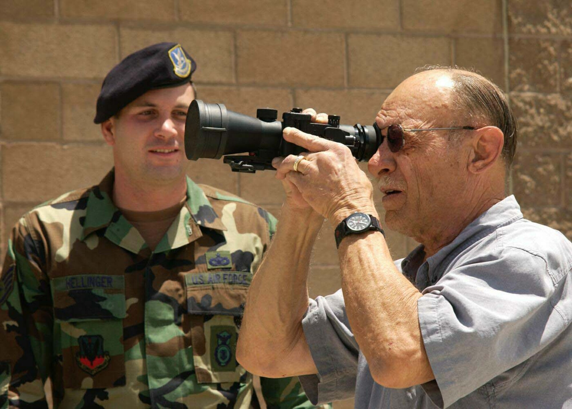 DAVIS-MONTHAN AIR FORCE BASE, Ariz. -- Staff Sgt. Scott Hellinger shows Eugene Krzyzopolski night-vision equipment here May 17 during National Police Week.  Sergeant Hellinger is assigned to the 355th Security Forces Squadron, and Mr. Krzyzopolski is a retired Airman.  (U.S. Air Force photo by Airman 1st Class Christina D. Ponte)