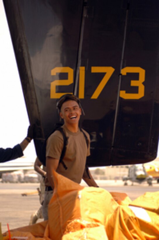 U.S. Navy Petty Officer 3rd Class Anthony Moreno helps load hundreds of pounds of mail onto a C-2A Greyhound at Aviation Support Unit Bahrain on May 15, 2005. The Greyhound is assigned to Fleet Logistics Support Squadron 30 that is conducting Carrier Onboard Delivery logistics support for the USS Carl Vinson (CVN 70). The Vinson Strike Group is in the Arabian Gulf conducting Maritime Security Operations. Moreno is a Navy Aviation Machinists Mate. 