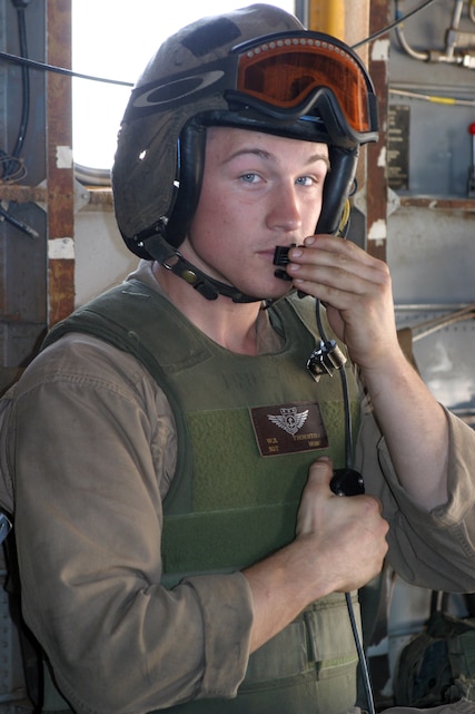 AL ASAD, Iraq - Sgt. Seth Thornton, a CH-53E Super Stallion crewchief assigned to Marine Heavy Helicopter Squadron 465, talks with the helicopter aircraft commander after shutting down the aircraft after a mission May 19.  Thornton, from Abilene, Texas, is on his third deployment to Iraq in support of Operation Iraqi Freedom.