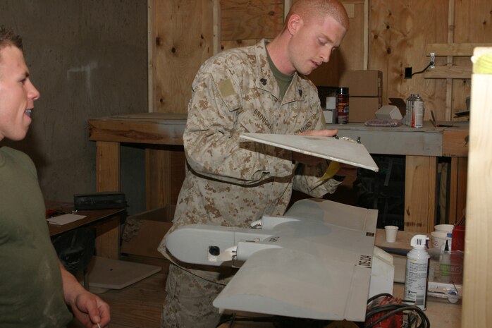 CAMP TAQADDUM, Iraq (May 19, 2005) - Sergeant Patrick W. Broughal, a Pinebrush, N.Y., native, sands a damaged Dragon Eye unmanned aerial vehicle here. Broughal, is one of three Marines from 4th Echelon Section, Electronics Maintenance Platoon, Maint. Detachment, Combat Logistics Regiment 25, 2d Force Service Support Group (Forward), who are responsible for repairing all the Dragon Eyes for the Marine Corps.