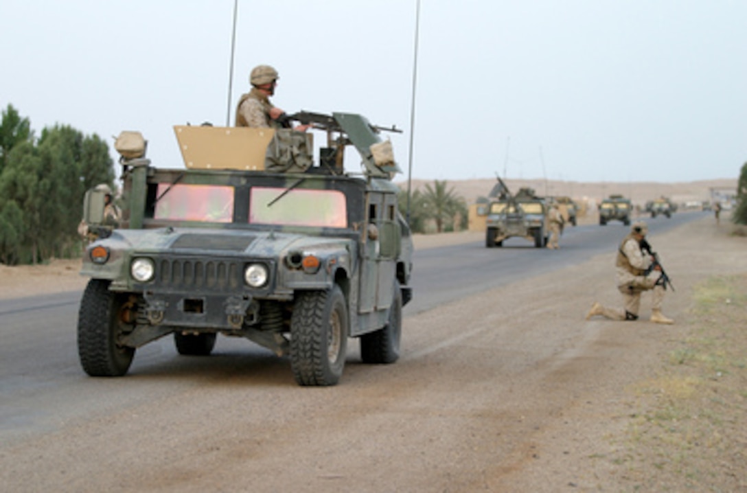 U.S. Army soldiers and Marines conduct a route reconnaissance of Alternate Service Road Boston in search of improvised explosive devices or mines on May 13, 2005. The Marines and soldiers are conducting route reconnaissance on roads that connect Camp Al Taqaddum and Camp Al Fallujah in Iraq. 