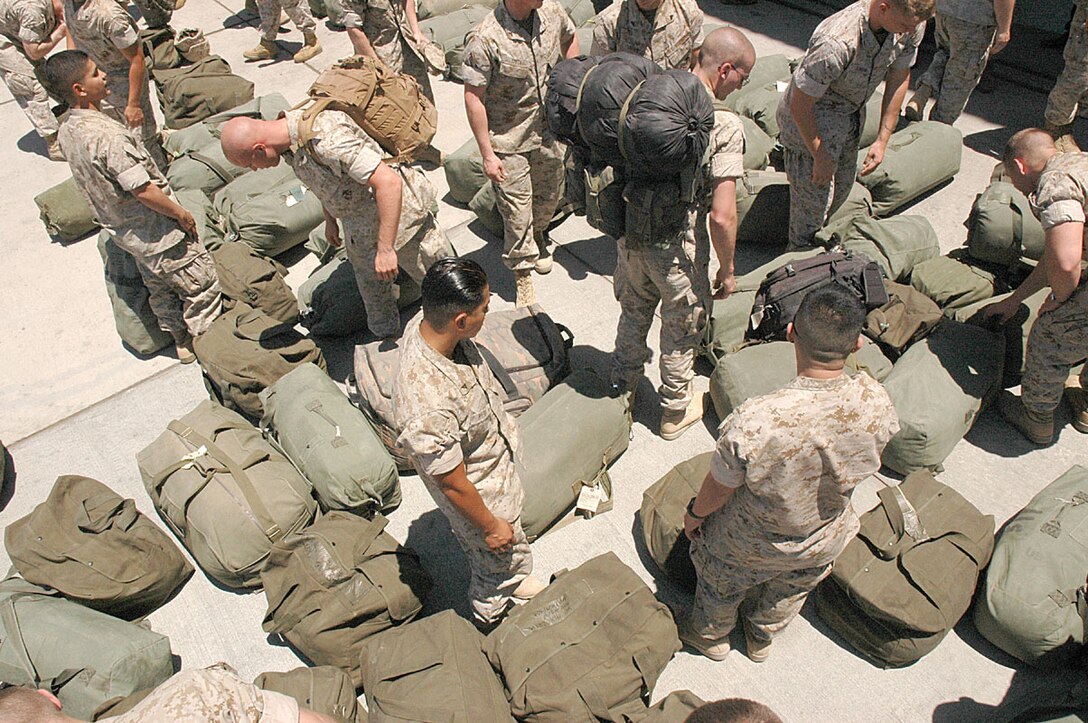 Marines and sailors from Marine Attack Squadron-311 and Marine Aviation Logistics Squadron-13 search for their seabags May 19 after seeing their family and friends for the first time after a six-month deployment to Iraq.