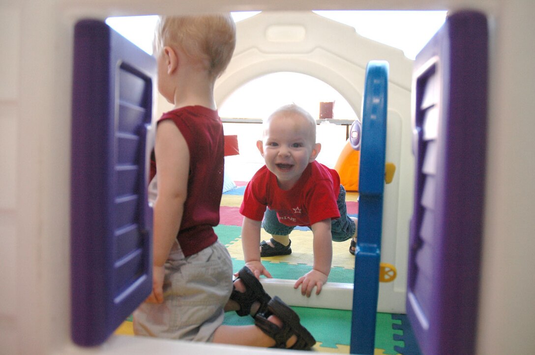 Justin VanDeberg, 13 months, plays in a play pen area May 19 that was set up for children while families and friends waited for Marines and sailors from Marine Attack Squadron-311 and Marine Aviation Logistics Squadron-13 to return from a six-month deployment to Iraq.