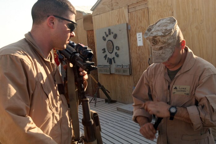 Marines with Maintenance Company, CLB-6, 2nd MLG (Fwd), clean their weapons while on call for vehicle recoveries that take place in the Iraq's Al Anbar Province.