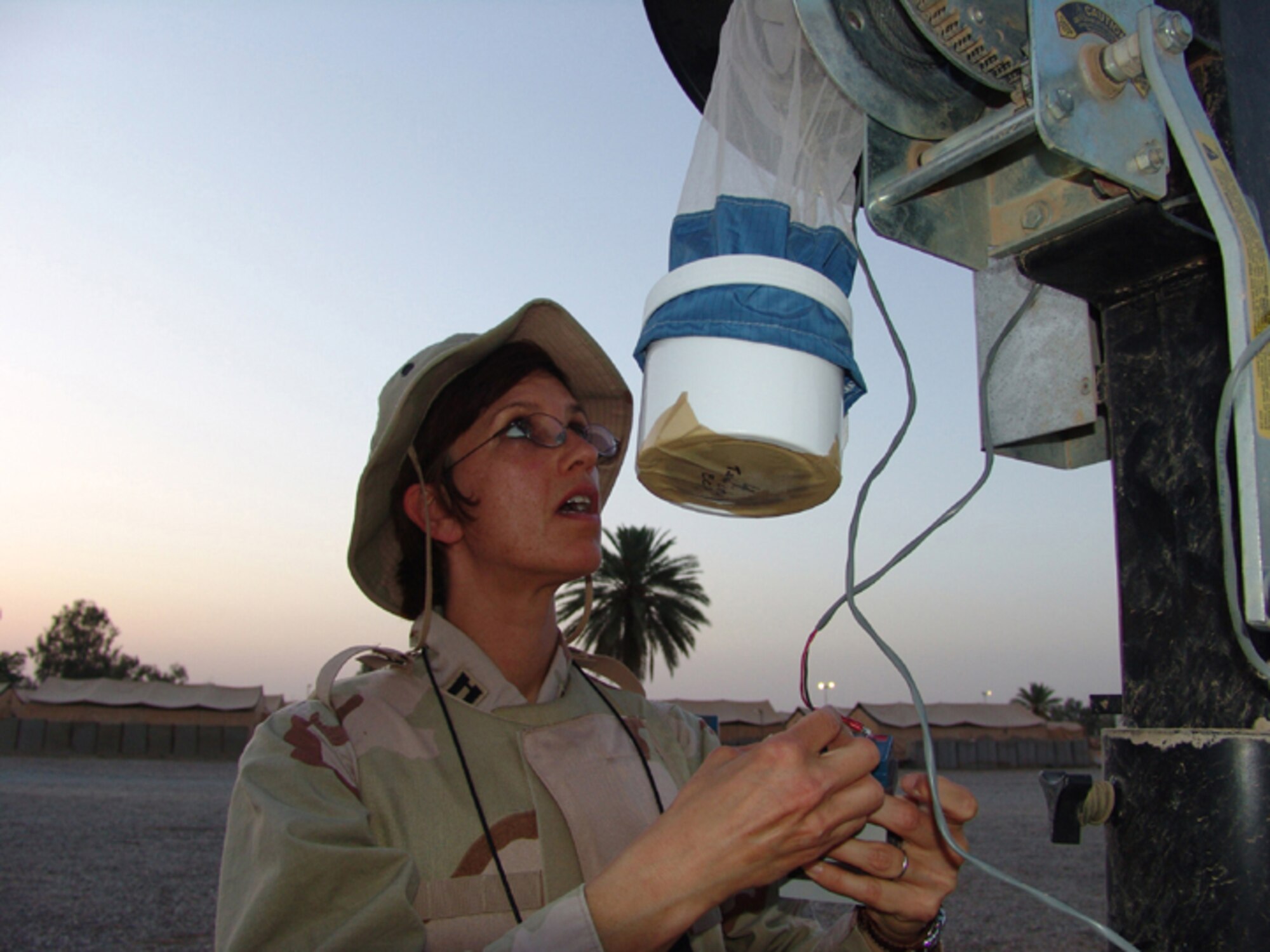 BAGHDAD, Iraq -- Capt. Gabrielle Childs sets a trap to catch sand flies and mosquitoes that will be tested for insect-borne diseases that threaten U.S. forces deployed to Iraq.  She is assigned to the 447th Expeditionary Medical Squadron's public health flight and is deployed from Luke Air Force Base, Ariz.  (U.S. Air Force photo by Tech. Sgt. Brian Davidson)            