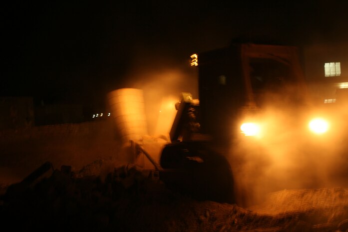 Marines from Engineer Company take down a building in southwest Fallujah, Iraq insurgents have been known to use for hiding. They did this in an attempt to fortify a nearby Iraq Police Station. During the mission, they also placed a concertina wire fence, disposed of unexploded ordnance and repaired a pothole in front of the station. They were later met by Transportation Support Company which place 55 concrete barriers to stregthen the building against insurgent attacks.