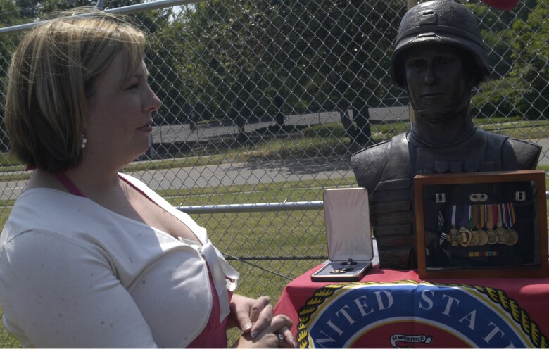 Amy Morel, wife of Capt. Brent L. Morel, stares into the bronze statue of her husband May 21, at a ceremony held by Company K, 3rd Battalion, 23rd Marine Regiment, 4th Marine Division, Marine Forces Reserve, Marine Corps Training Center in Memphis, Tenn. Amy recieved the Navy Cross on behalf of Brent, for his valor actions which led to his death April 7, 2004, in Fallujah, Iraq.