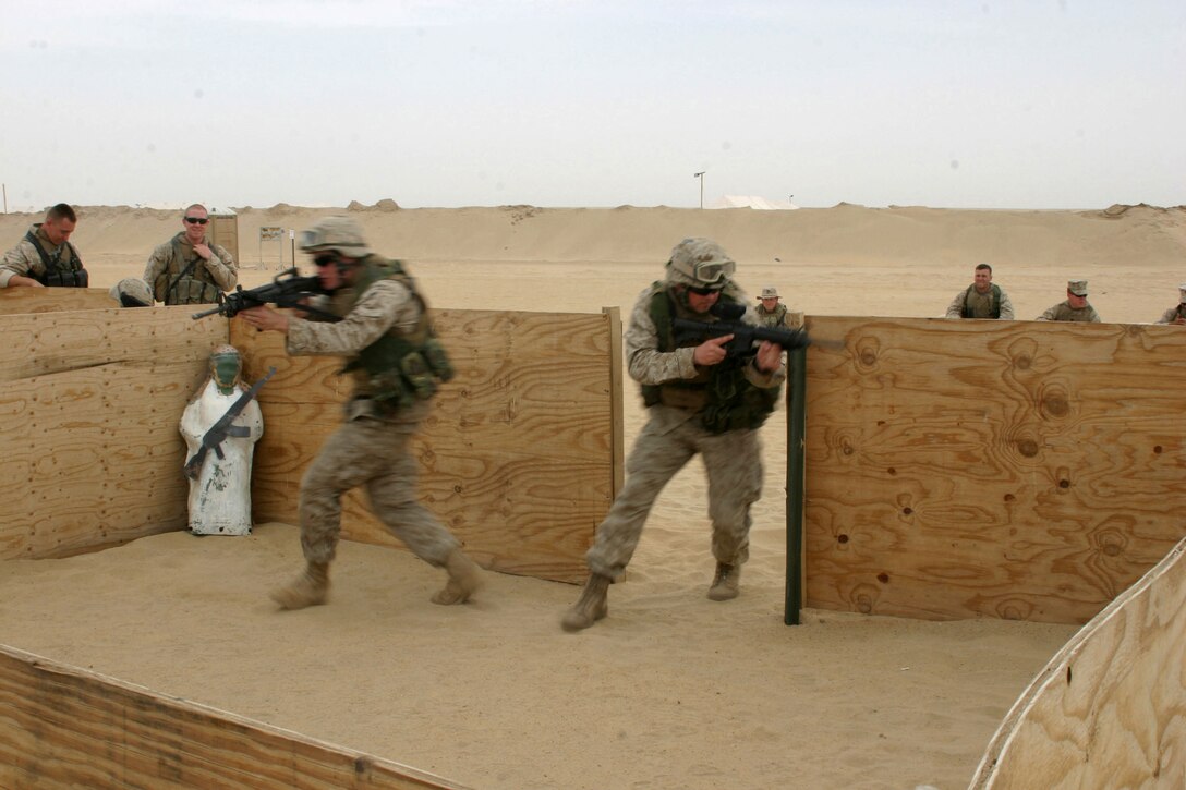 Private First Class Matthew A. Yowell and Sgt. Leonard W. Sanders of Combined Anti-Armor Team "Alpha", Weapons Company, Battalion Landing Team, 2nd Bn., 8th Marines, 26th Marine Expeditionary Unit (Special Operations Capable), practice room clearing in model prior to a live fire exercise at Udairi Range, near Camp Buehring, Kuwait. Marines of the 26th MEU will continue live fire exercises in preparations for follow-on operations in the region. (USMC photo by Cpl. Eric R. Martin)(Released)