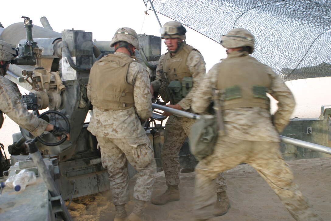 Marines of 4th gun India battery, 3rd battalion 10th Marines, attached to the Battalion Landing Team 2nd Bn, 8th Marines, 26th Marine Expeditionary Unit (Special Operations Capable), load a 155mm round into a 198 towed howitzer May 23 at Udairi Range, gun point PA03, Camp Buehring, Kuwait.  As the theatre reserve, for Central Command, Marines of the 26th MEU (SOC) are conducting live fire exercises at Udairi Range, near Camp Buehring, Kuwait in preparation for potential follow-on missions in the region. (USMC photo by LCpl. Daniel R. Lowndes) (Released)
